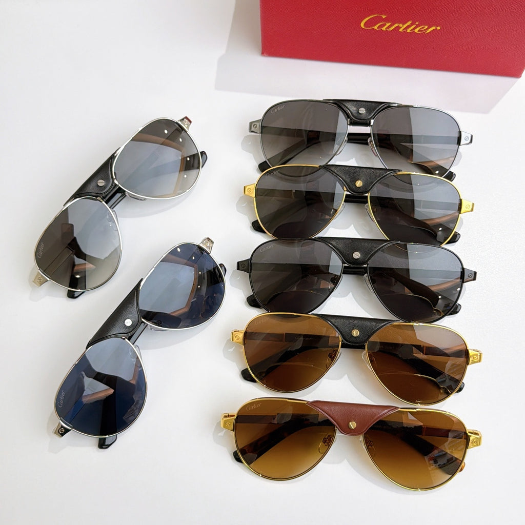 Cartier sunglasses assortment with mixed frames and tinted lenses, laid out