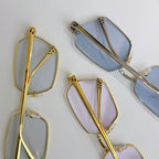 Cartier glasses frame close-up: gold and silver temples and clear lenses