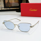 Gold-tone cat-eye sunglasses with light blue lenses and textured temple detail