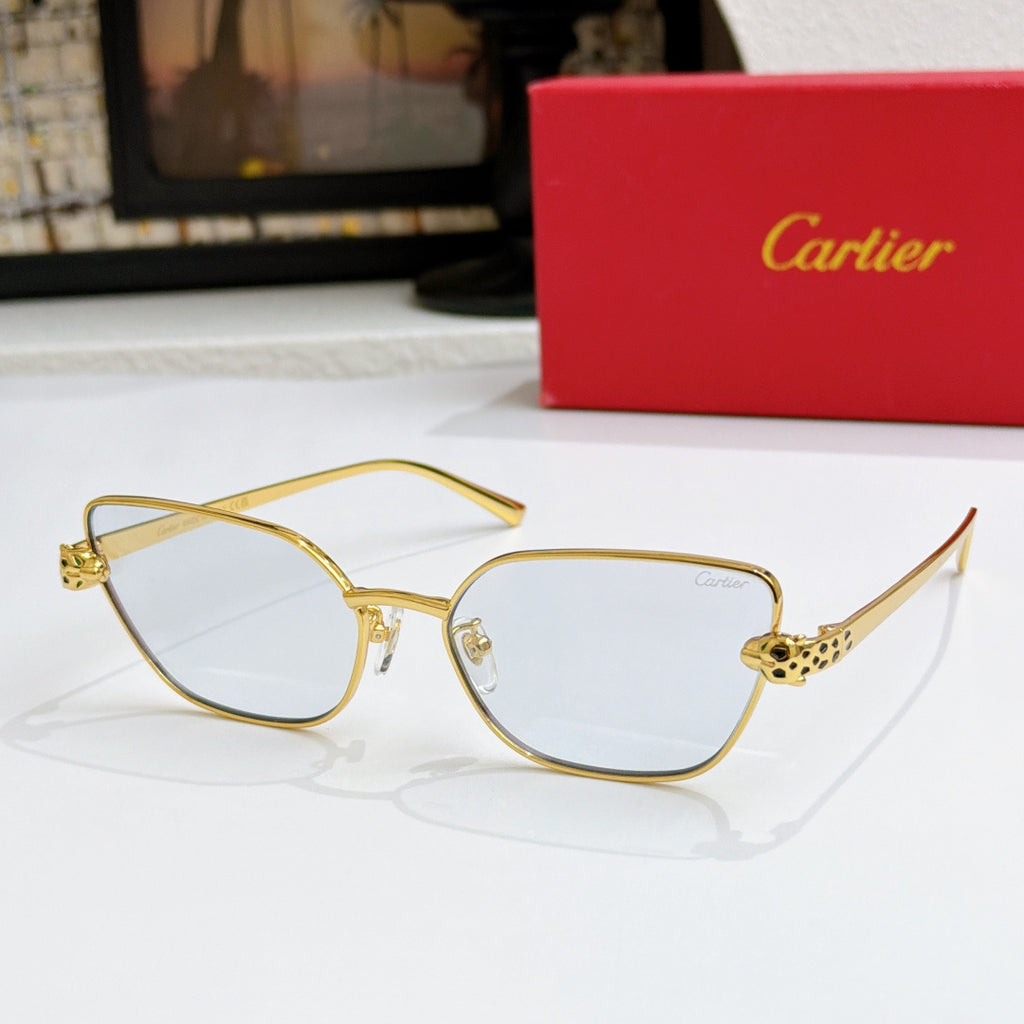 Gold-tone cat-eye sunglasses with pale lenses and textured temple detail