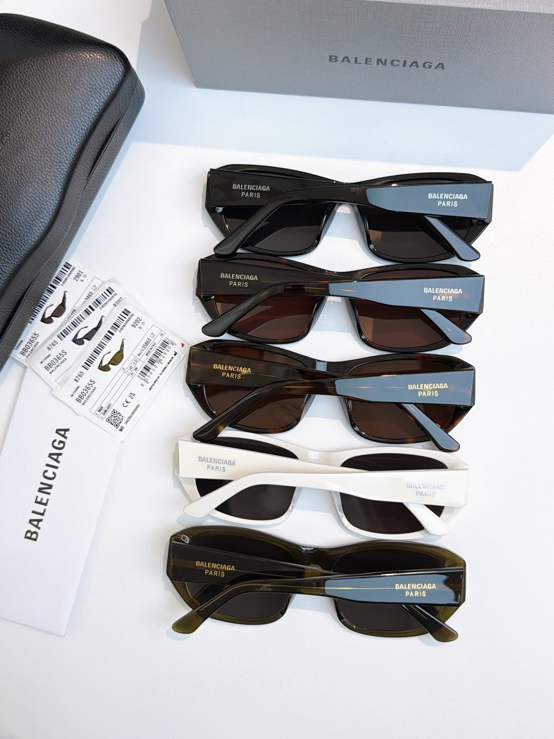 Balenciaga sunglasses assortment: black, white, brown, and green frames with dark lenses
