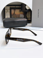 Balenciaga tortoise sunglasses with dark lenses and sleek side profiles