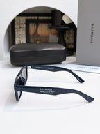 Balenciaga navy sunglasses with dark lenses and slim side arms