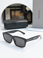 Balenciaga black cat-eye sunglasses with dark tinted lenses and curved arms
