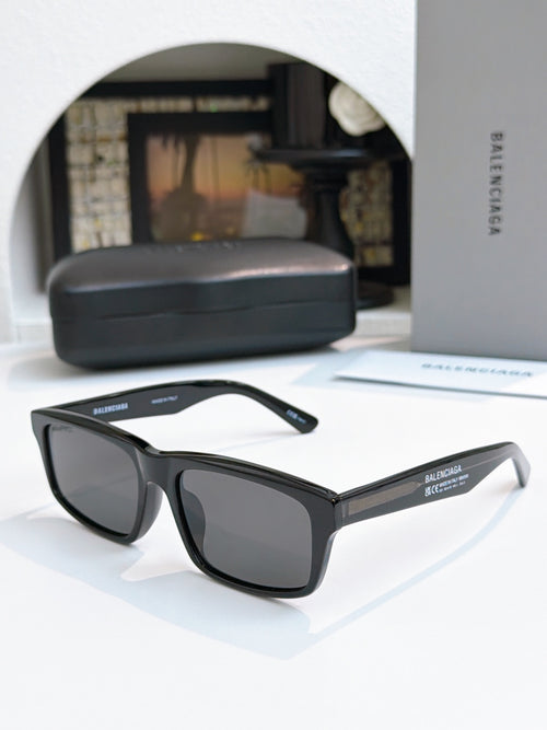 Balenciaga black cat-eye sunglasses with dark tinted lenses and curved arms