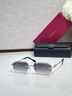 Cartier sunglasses with smoky gray lenses and black frame, gold hinge accents
