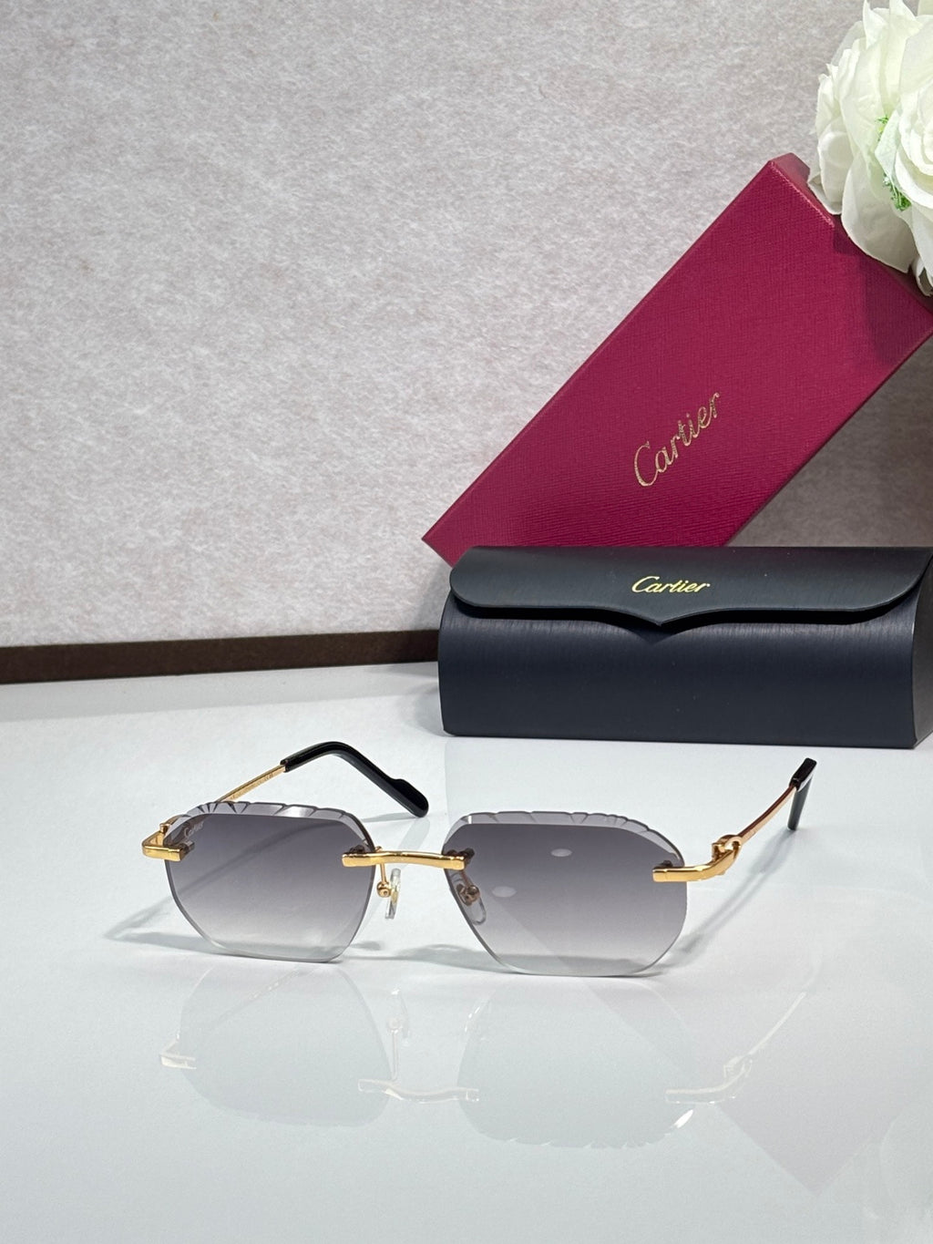 Cartier sunglasses with dark gray lenses and gold frame with black temples