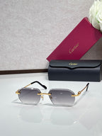 Cartier sunglasses with dark gray lenses and gold frame with black temples