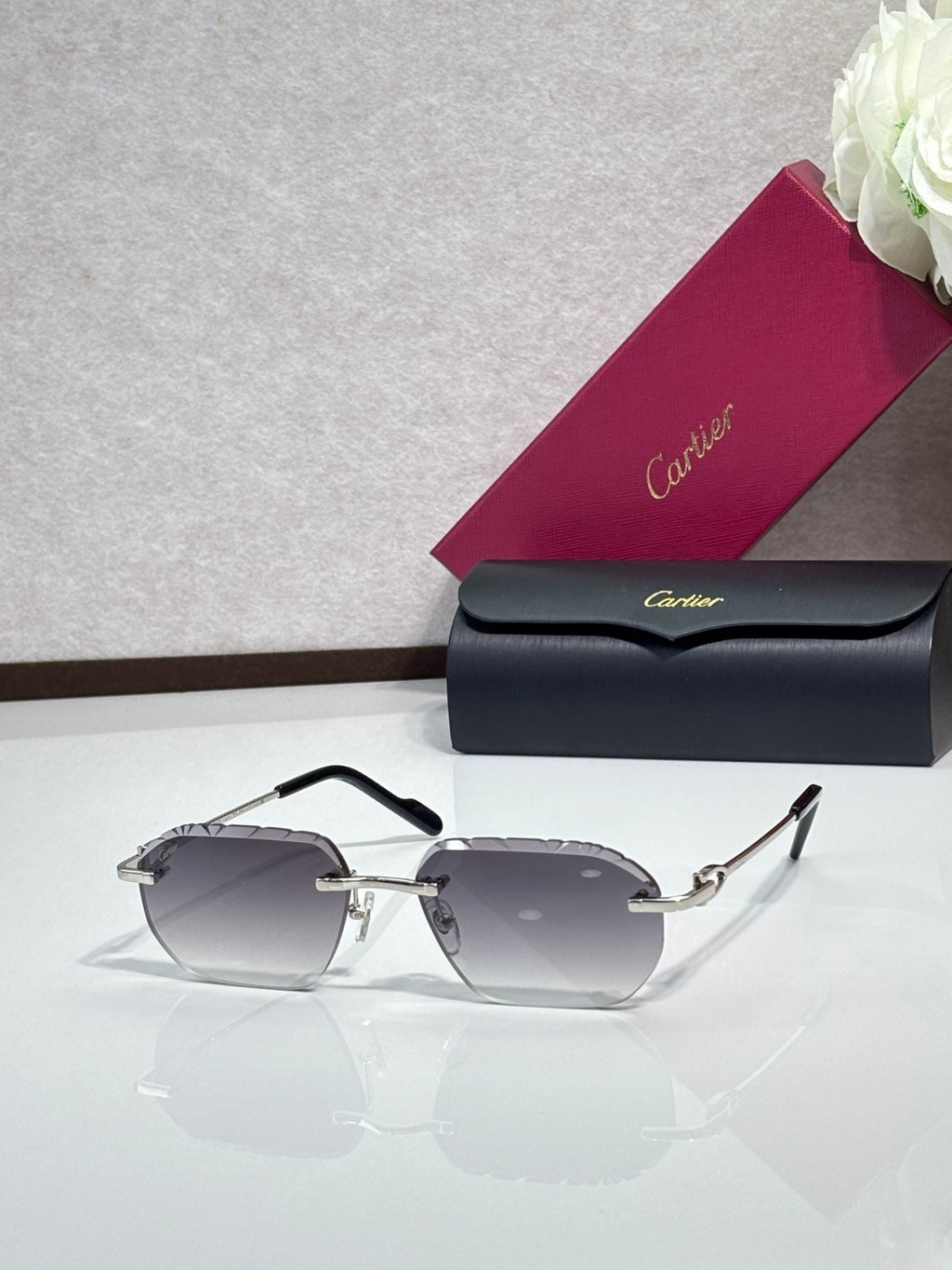 Cartier sunglasses with gray lenses and black frame, gold temple details