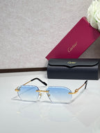 Cartier sunglasses with light blue lenses and gold frame