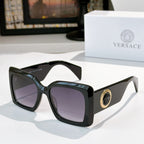 Versace sunglasses with black square frames and purple-tinted lenses, gold logo detail