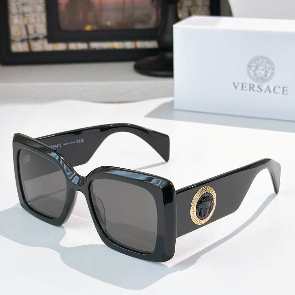 Versace sunglasses with black square frames and tinted lenses, gold logo detail on temple