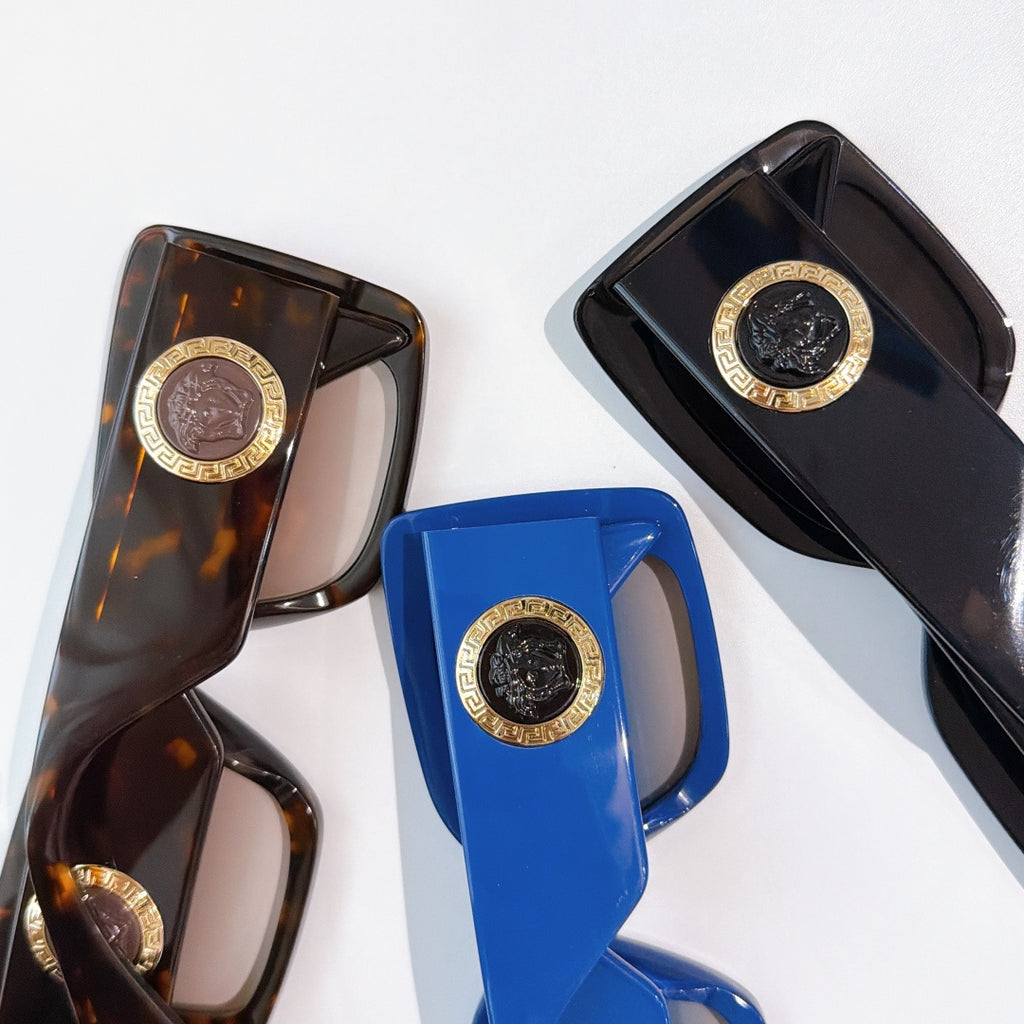 Versace sunglasses assortment with tortoiseshell, blue, and black frames, gold logo hinges