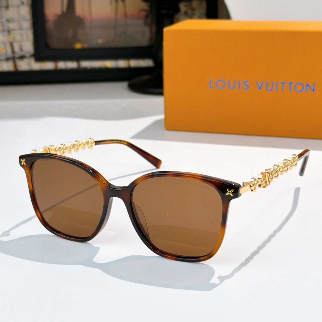 Louis Vuitton sunglasses with dark tortoiseshell frames, gold chain temples, brown tinted lenses