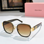 MiuMiu cat-eye sunglasses with dark frame and amber tinted lenses, gold accents