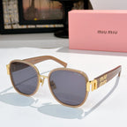 MiuMiu cat-eye sunglasses with light brown frame and blue-gray tinted lenses, gold accents