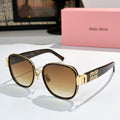 MiuMiu cat-eye sunglasses with dark tortoise frame and brown gradient lenses, gold accents