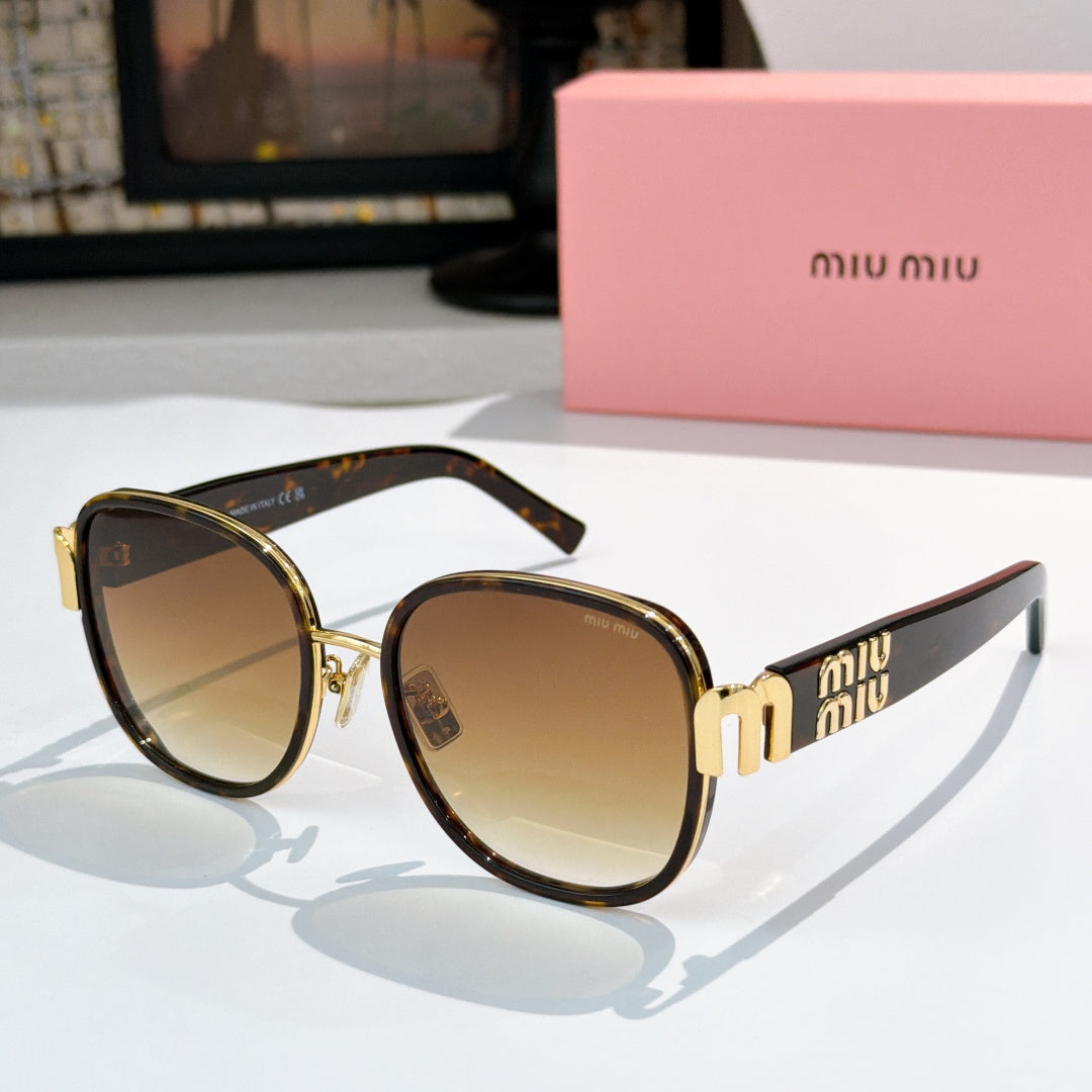 MiuMiu cat-eye sunglasses with dark tortoise frame and brown gradient lenses, gold accents