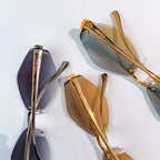 Cartier glasses close-up with dark lenses and gold frame, curved temple detail
