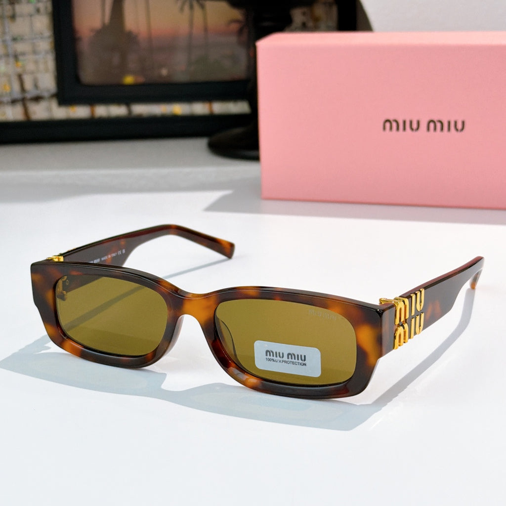 MiuMiu tortoiseshell oversized sunglasses with green-tinted lenses and gold logo temple