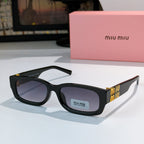 MiuMiu black oversized sunglasses with dark lenses and gold logo temple detail