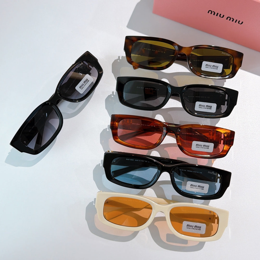 Four pairs of MiuMiu sunglasses in black, tortoiseshell and cream with tinted lenses