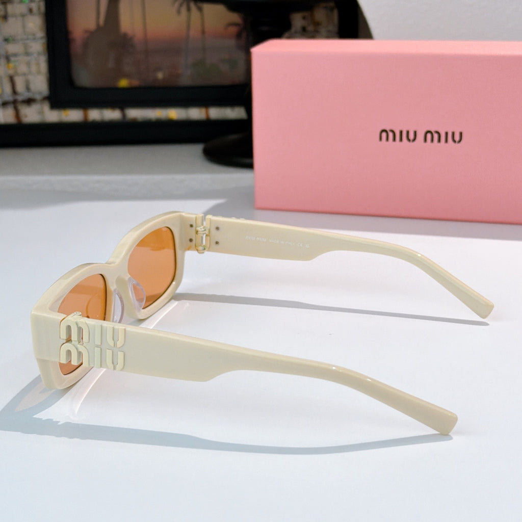 MiuMiu cream sunglasses with amber lenses, gold logo temple and metal hinge detail