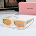 MiuMiu cream oversized sunglasses with amber-tinted lenses and gold logo temple