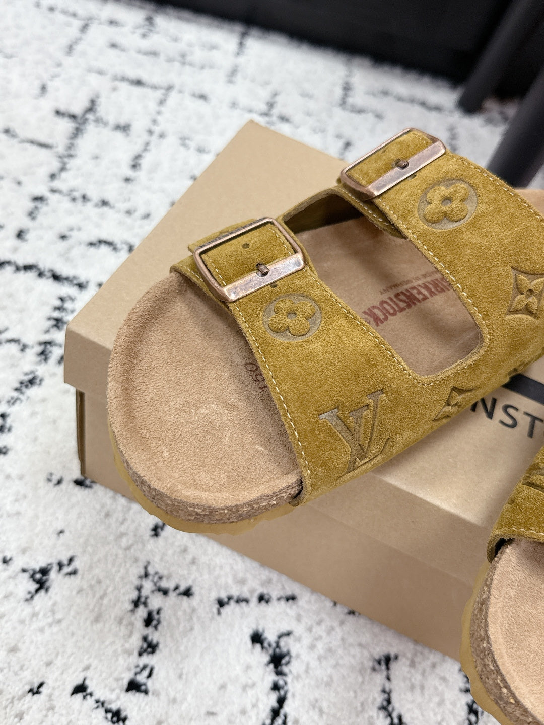 Louis Vuitton mustard slide sandals with two buckled straps and embossed monogram pattern