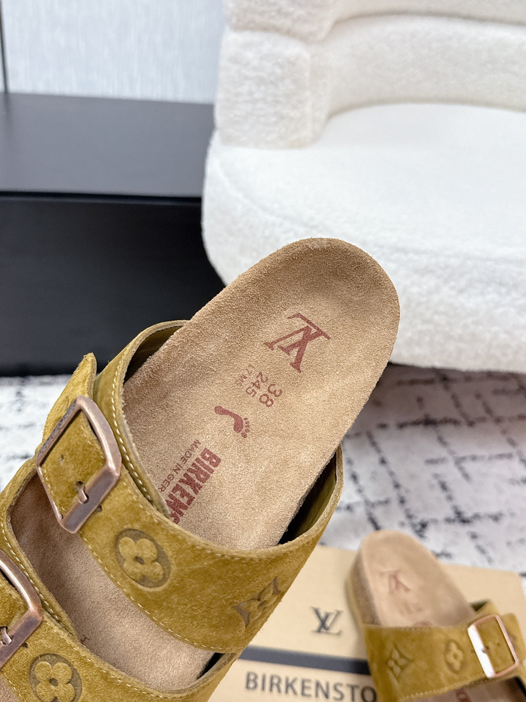 Louis Vuitton mustard slide sandals close-up with buckled strap and suede lining