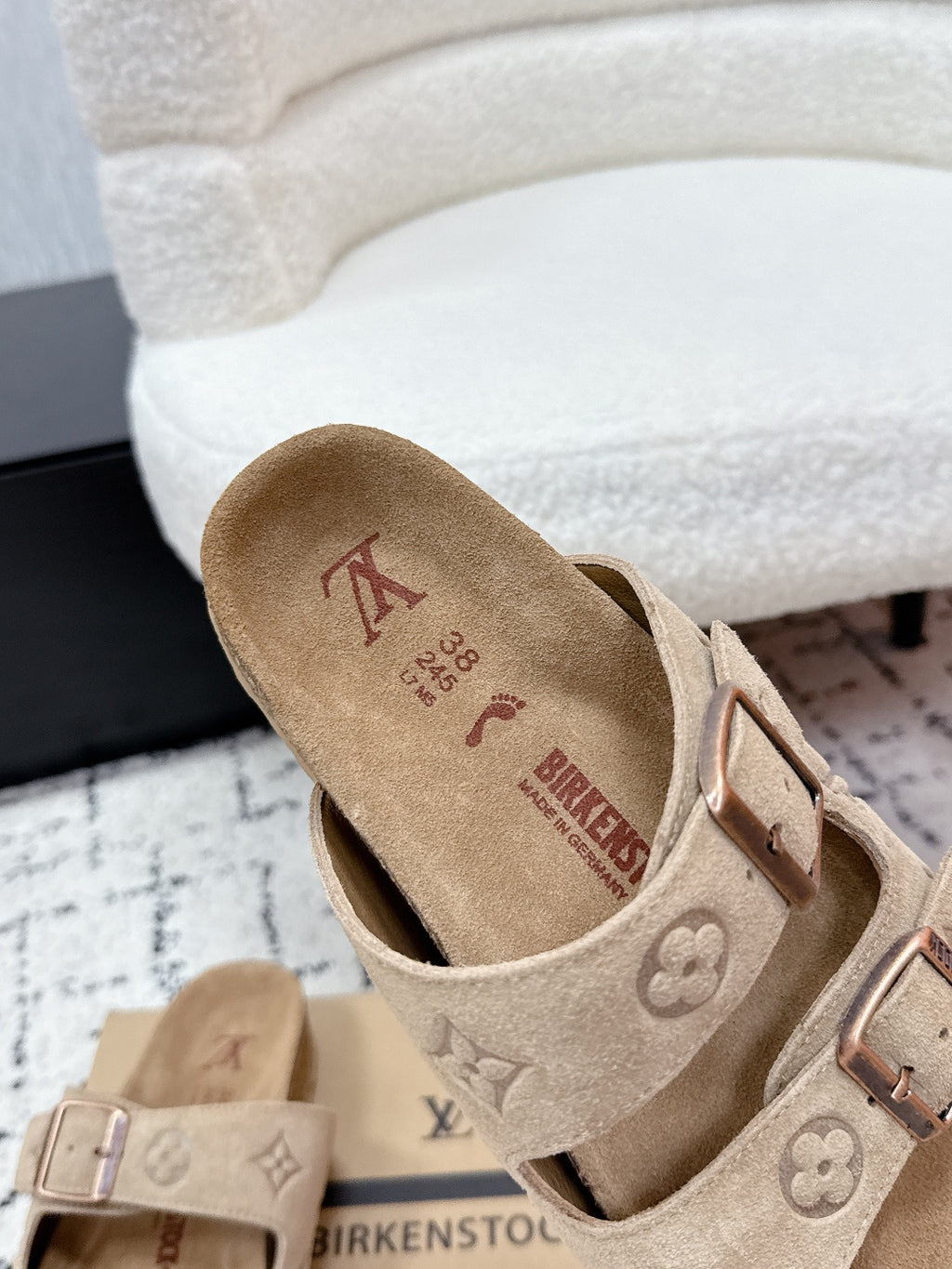 Beige Birkenstock-style Louis Vuitton slide sandal close-up of suede footbed and buckle.