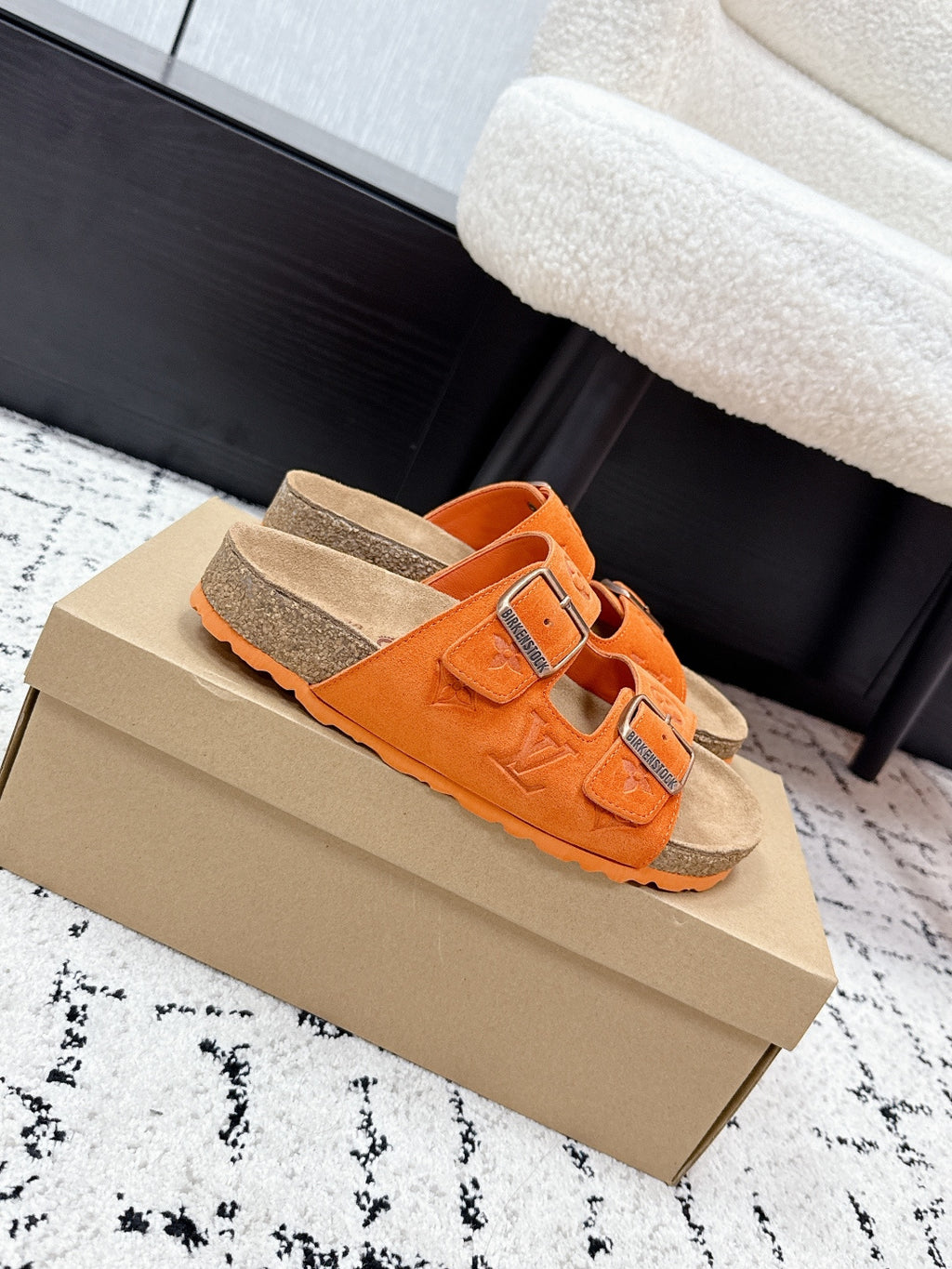 Orange slip-on sandals with two adjustable straps and silver buckles
