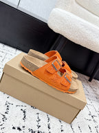 Orange slip-on sandals with two adjustable straps and silver buckles