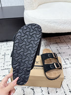Louis Vuitton slide sandals, tread sole with dark logo pattern and black strap upper