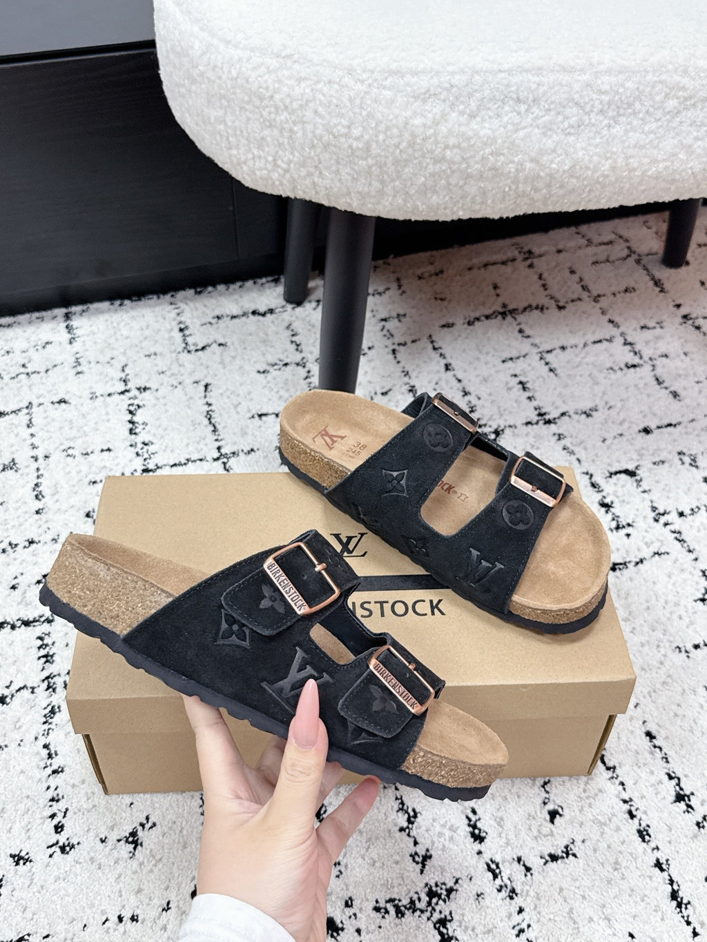 Louis Vuitton slide sandals, black suede with LV-style monogram and metal buckle details
