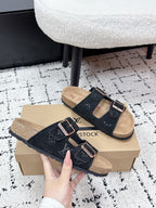 Louis Vuitton slide sandals, black suede with LV-style monogram and metal buckle details