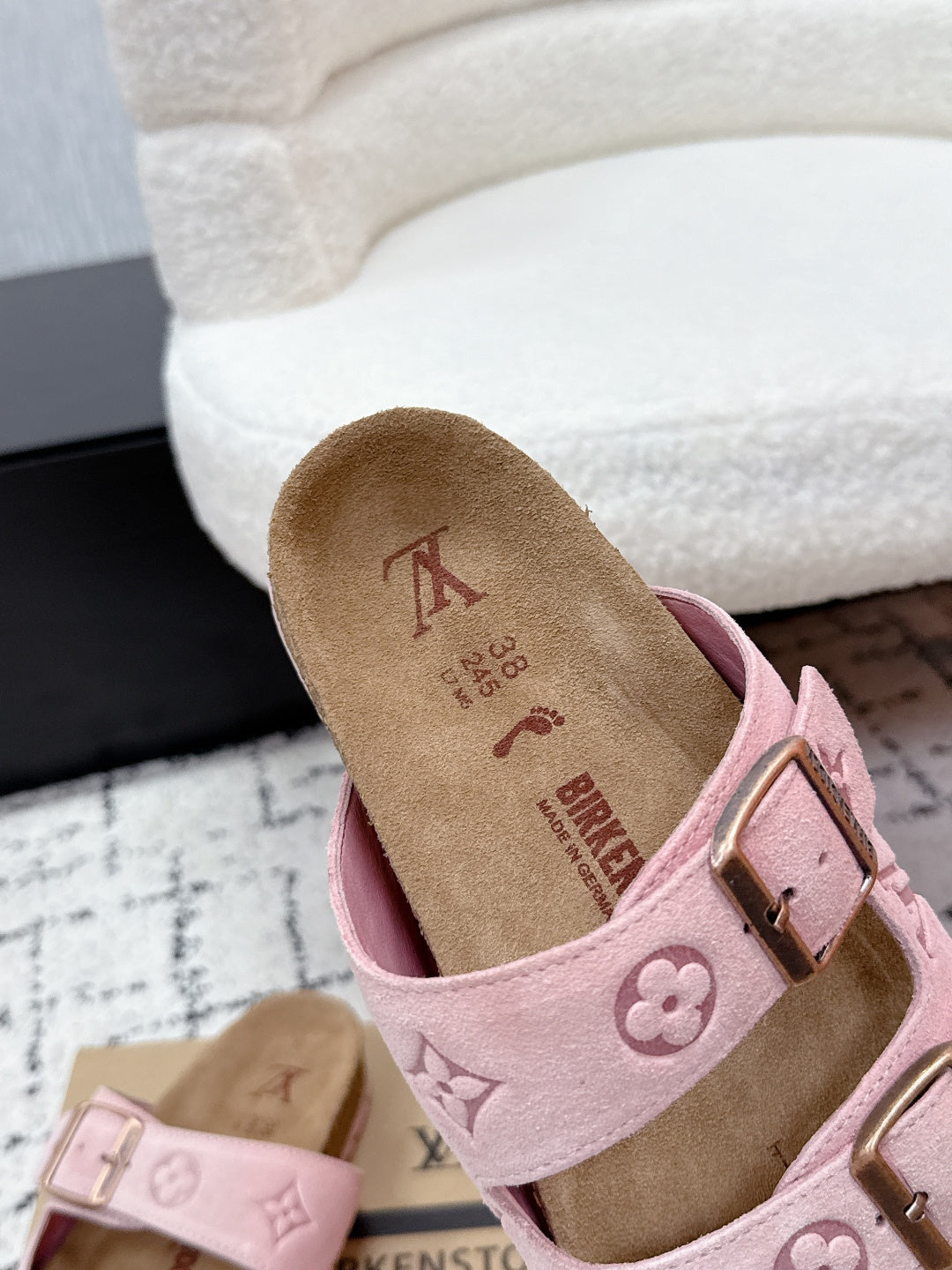 Louis Vuitton pink sandal close-up on footbed and strap detail, logo text visible