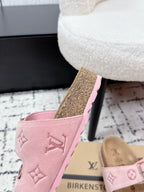 Louis Vuitton pink slip-on sandals with monogram upper and textured sole, angled