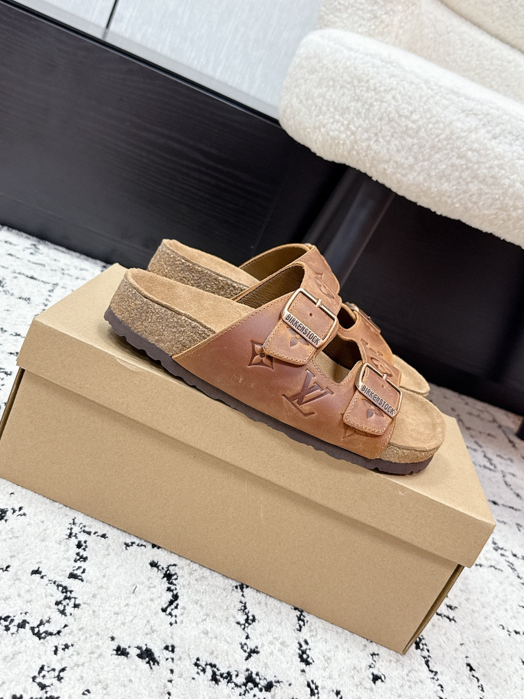 Tan Louis Vuitton monogram slide sandals, side view on box with buckle straps