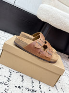 Tan Louis Vuitton monogram slide sandals, side view on box with buckle straps
