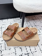 Tan Louis Vuitton monogram slide sandals with two buckle straps and footbed