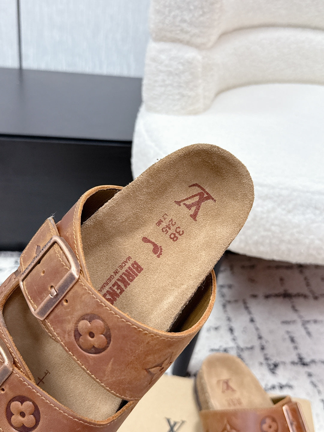 Tan Louis Vuitton slide sandal footbed with brand markings and logo
