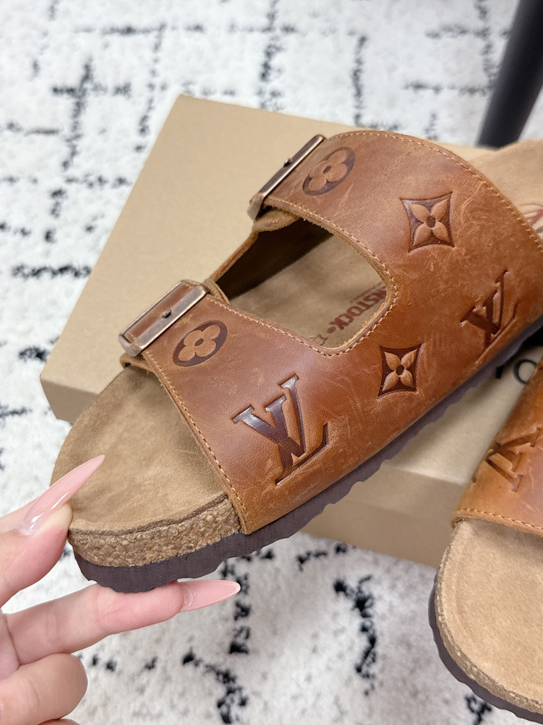 Tan Louis Vuitton monogram slide sandal close-up on box, two buckle straps
