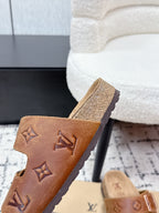 Tan Louis Vuitton monogram slide sandal close-up strap with buckle