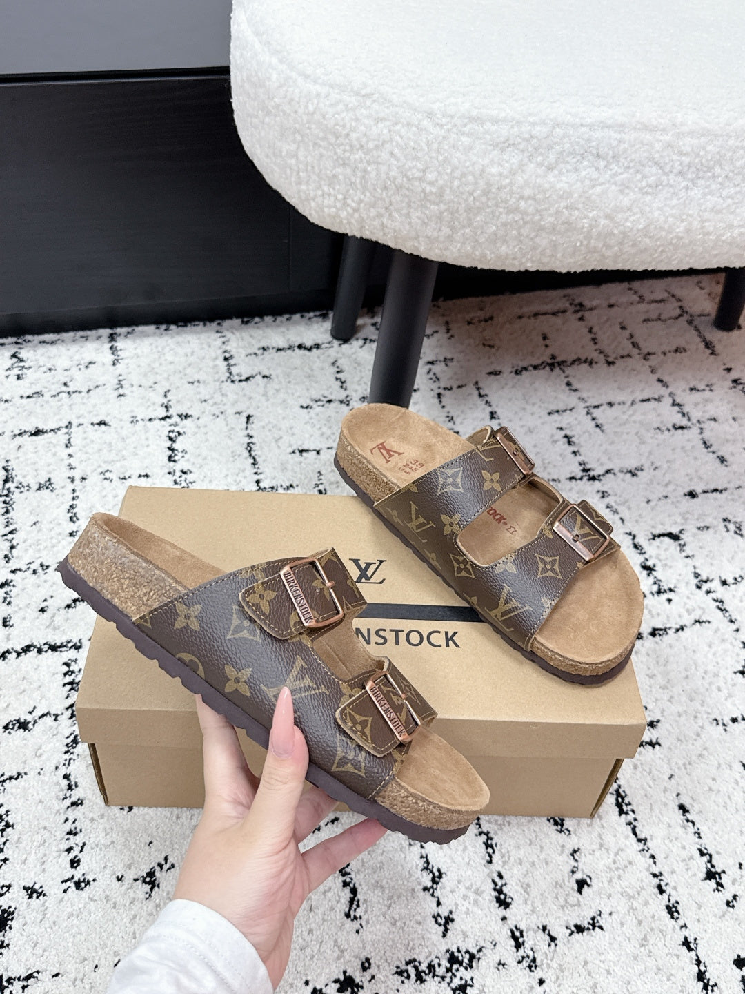Louis Vuitton monogram slide sandals with two adjustable buckle straps, tan sole.