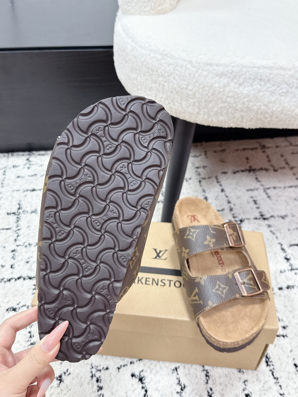 Louis Vuitton monogram slide sandals, patterned underside and tan strap detail.