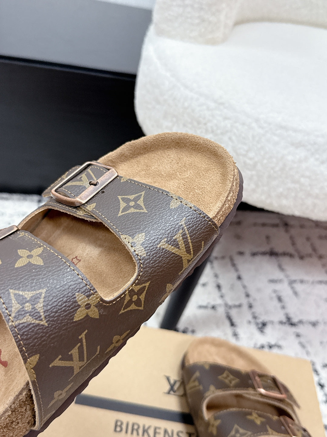 Louis Vuitton monogram slide sandal with open toe and adjustable buckle strap.