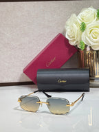 Rectangular gold-tone Cartier eyeglass frame with gray gradient lenses and black temples