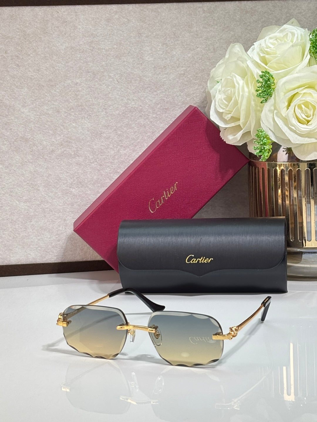 Rectangular gold-tone Cartier eyeglass frame with gray gradient lenses and black temples