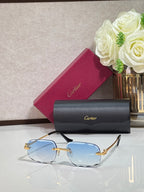 Rectangular gold-tone Cartier eyeglass frame with blue-tinted lenses and black temples